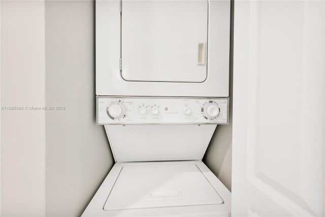 laundry room with stacked washer / drying machine