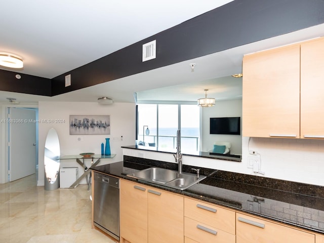 kitchen with sink, light brown cabinets, pendant lighting, dark stone countertops, and dishwasher