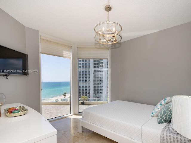 bedroom with access to outside and an inviting chandelier