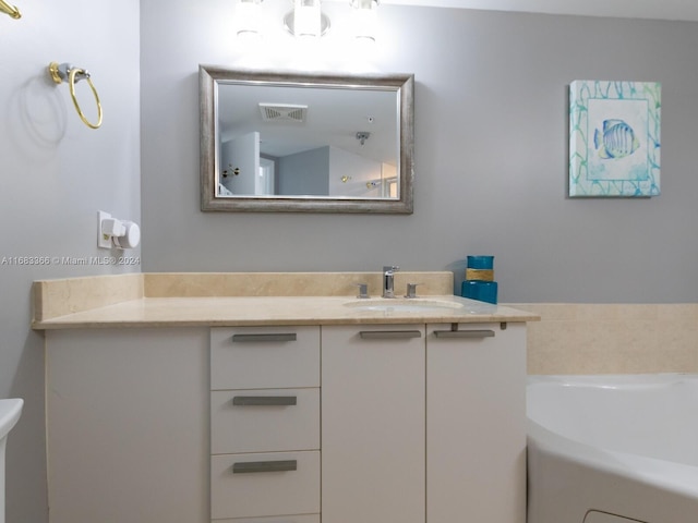 bathroom featuring vanity and a bath