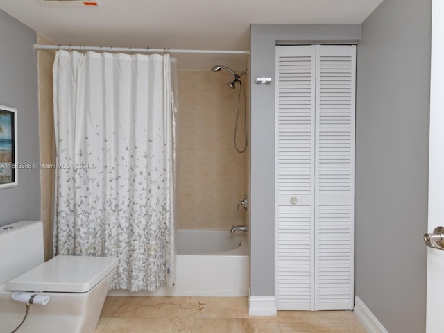 bathroom with toilet and shower / bath combo with shower curtain