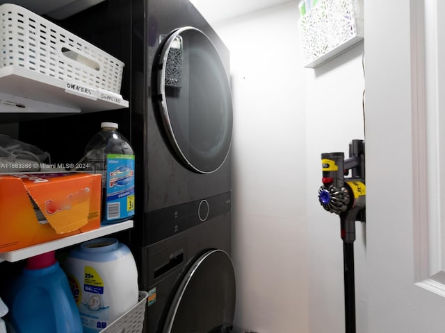 washroom featuring stacked washer and clothes dryer