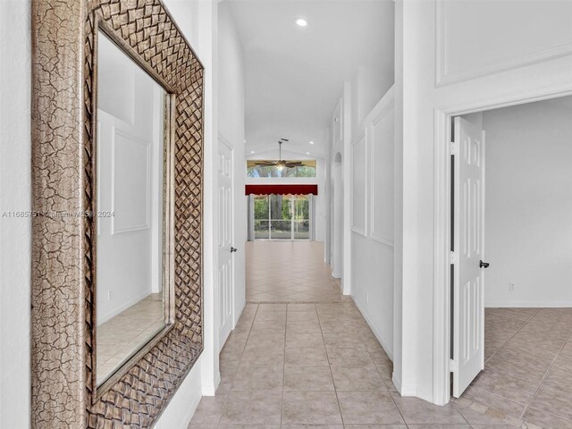 corridor with light tile patterned floors and recessed lighting