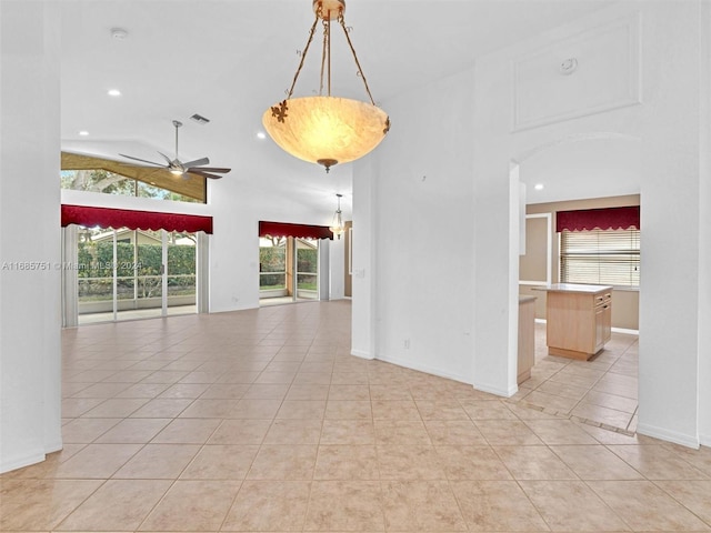 tiled spare room with lofted ceiling and ceiling fan