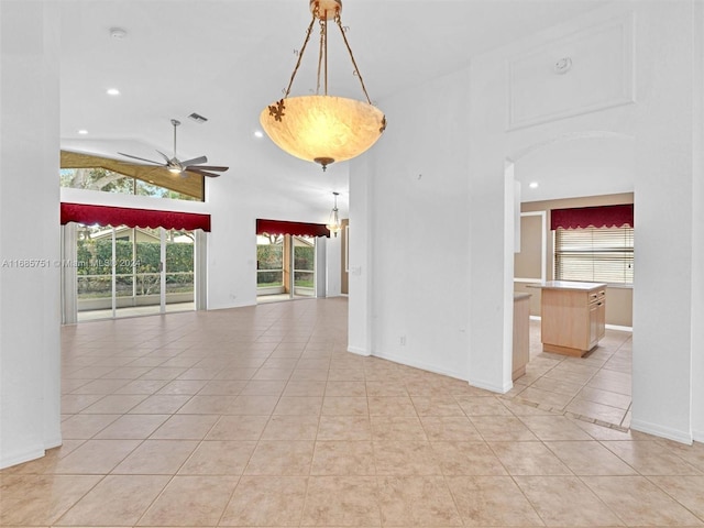 unfurnished room with light tile patterned floors, ceiling fan, recessed lighting, high vaulted ceiling, and baseboards