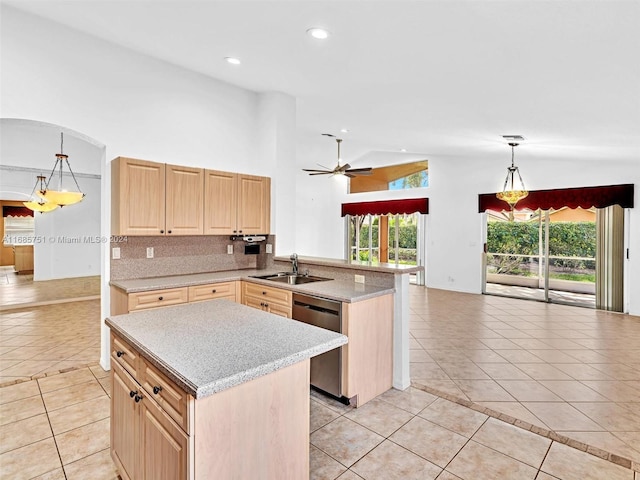 kitchen featuring kitchen peninsula, dishwasher, decorative light fixtures, and light brown cabinetry