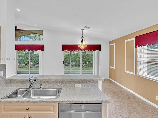 kitchen with stainless steel dishwasher, a sink, light tile patterned floors, light countertops, and ceiling fan