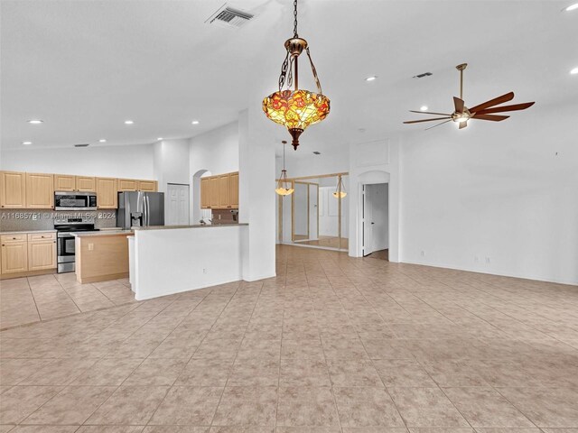 unfurnished living room with ceiling fan, arched walkways, high vaulted ceiling, light tile patterned floors, and recessed lighting