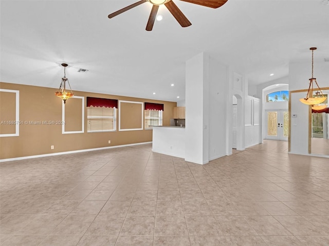 unfurnished living room featuring light tile patterned floors, recessed lighting, a ceiling fan, french doors, and arched walkways