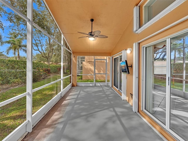 unfurnished sunroom with lofted ceiling and ceiling fan