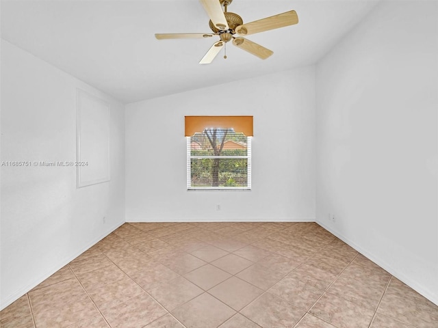 empty room featuring vaulted ceiling and a ceiling fan