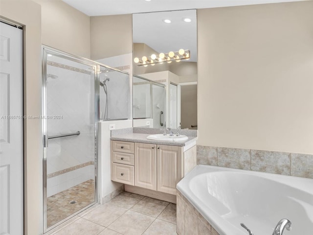 bathroom featuring vanity, independent shower and bath, and tile patterned floors