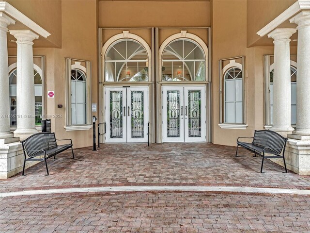 property entrance with french doors and stucco siding