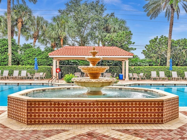 view of pool featuring a gazebo, pool water feature, and a patio