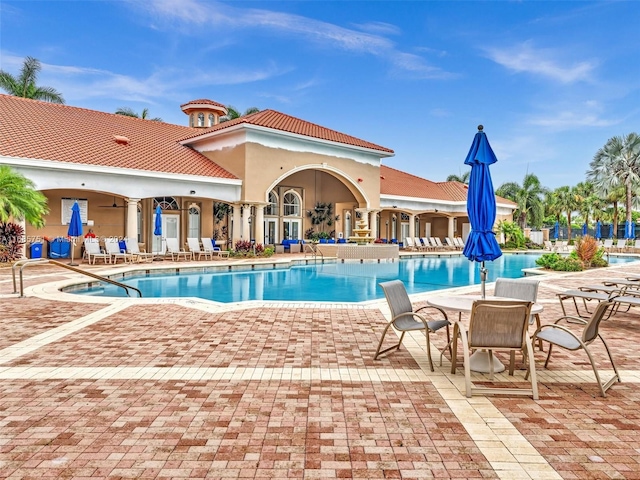 community pool with a patio area