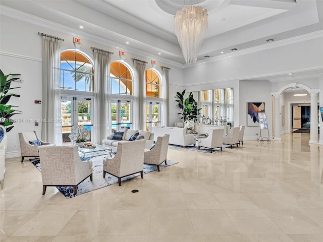 building lobby featuring a high ceiling, recessed lighting, and crown molding