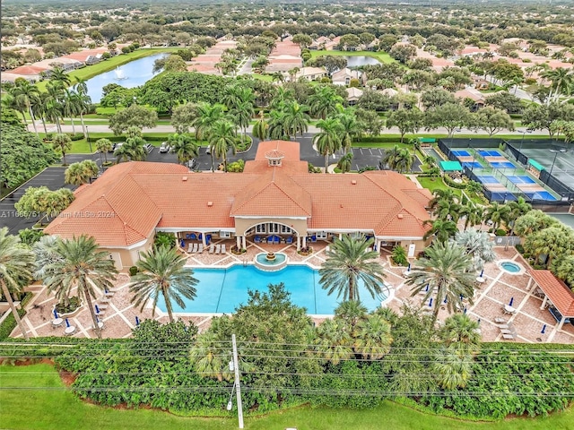 aerial perspective of suburban area with a large body of water and a pool