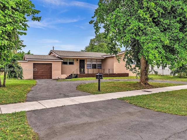 single story home with a front yard and a garage