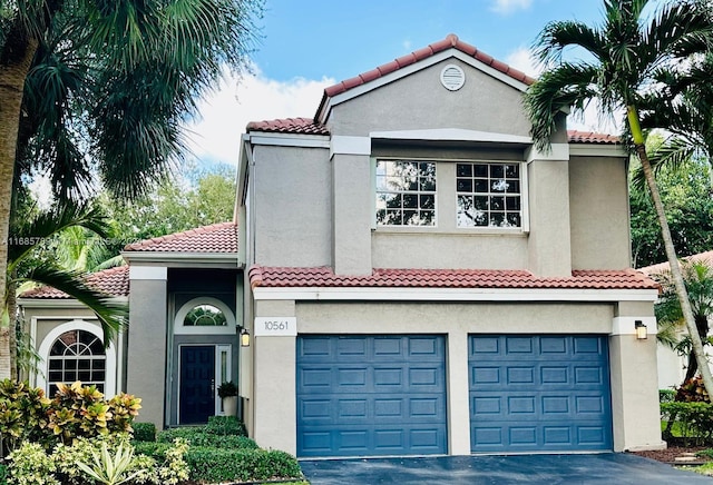 mediterranean / spanish house with a garage