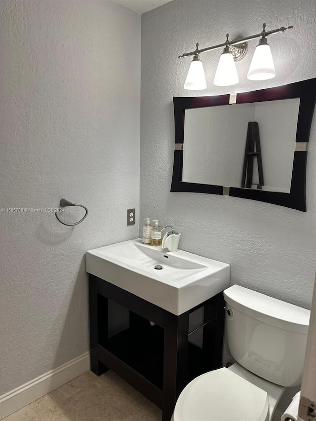 bathroom featuring vanity, toilet, and tile patterned floors