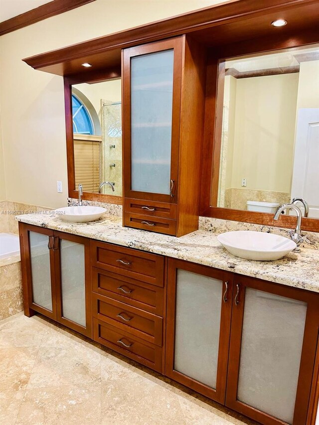 bathroom with vanity, ornamental molding, and separate shower and tub