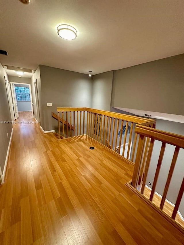 corridor with wood-type flooring