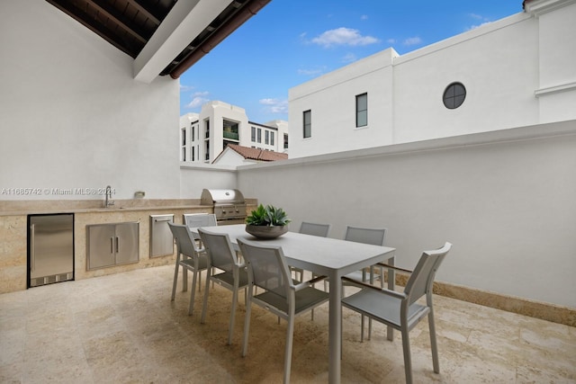 view of patio / terrace featuring sink, an outdoor kitchen, and grilling area