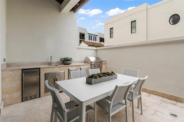 view of patio / terrace with an outdoor kitchen, sink, and a grill