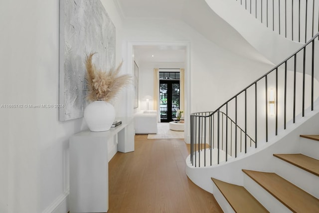 interior space with ornamental molding and hardwood / wood-style floors