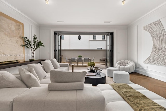 living room featuring crown molding and parquet floors