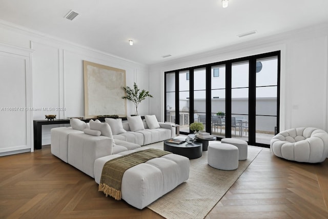 living room with parquet flooring and ornamental molding