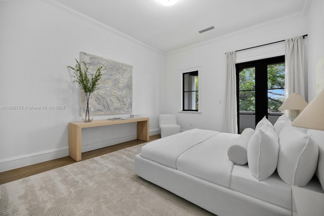 bedroom with crown molding and hardwood / wood-style flooring