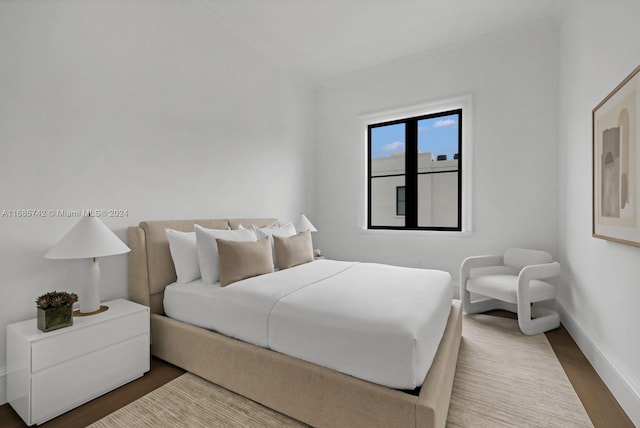 bedroom featuring crown molding and wood-type flooring