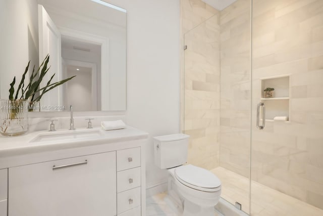 bathroom with a shower with door, vanity, and toilet