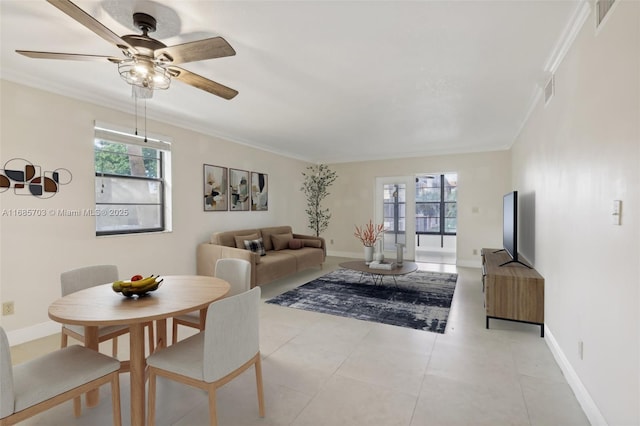 living room with light tile patterned floors, a wealth of natural light, and ornamental molding