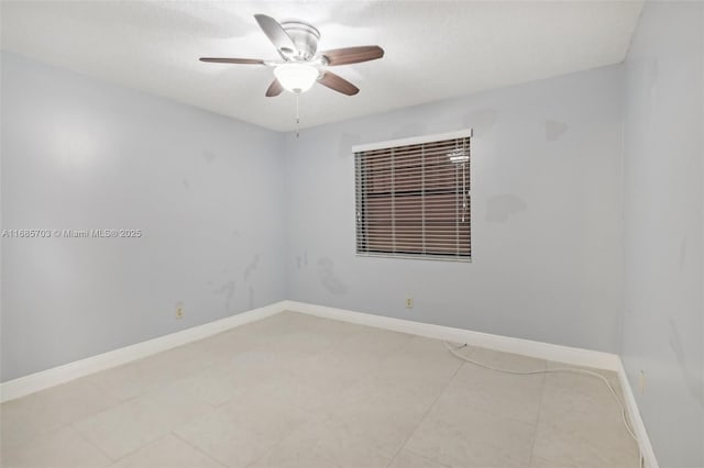 tiled empty room featuring ceiling fan