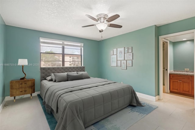 bedroom featuring ceiling fan, a textured ceiling, and ensuite bath