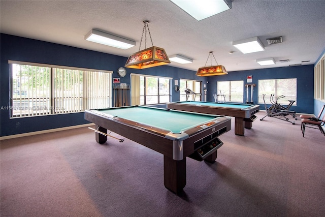 playroom featuring plenty of natural light, a textured ceiling, and carpet flooring