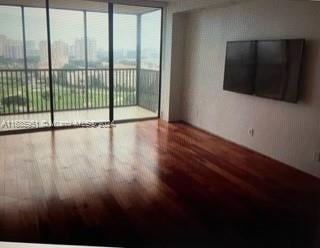 unfurnished room featuring hardwood / wood-style flooring and floor to ceiling windows