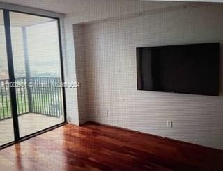 unfurnished living room featuring hardwood / wood-style flooring