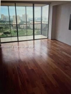 unfurnished room with hardwood / wood-style flooring