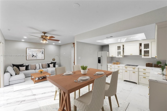 dining space with sink and ceiling fan