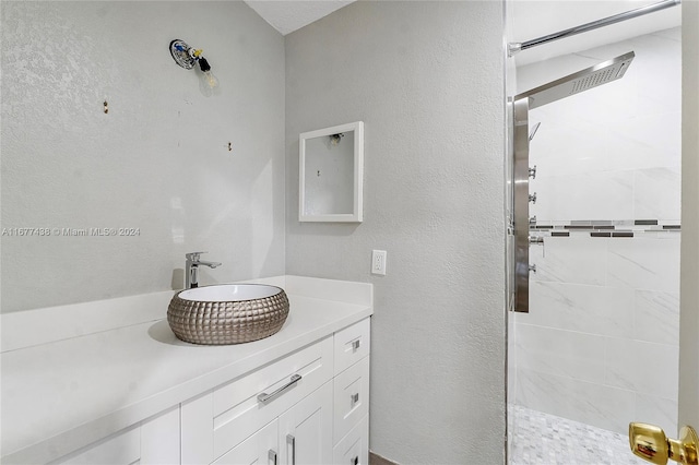 bathroom featuring vanity and tiled shower