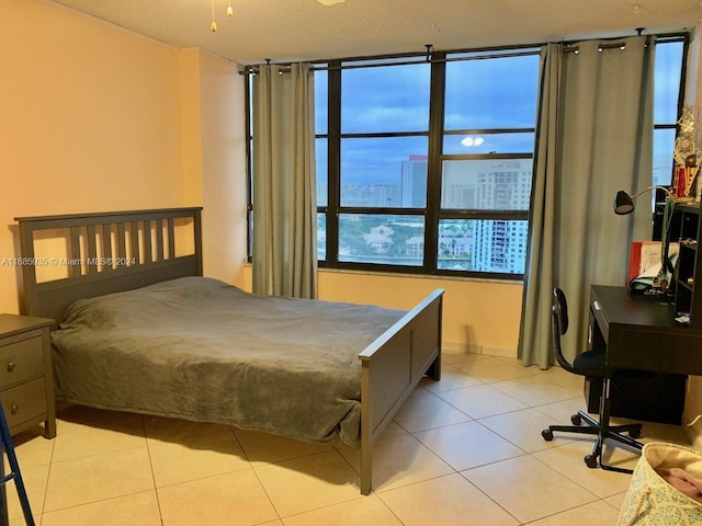 bedroom featuring multiple windows and light tile patterned floors