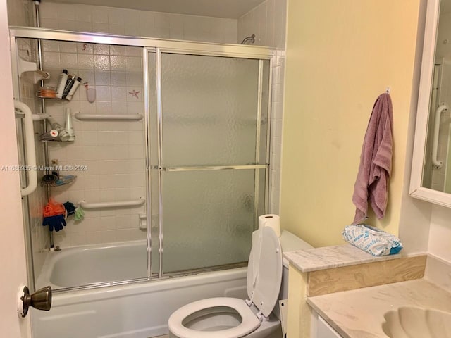 full bathroom featuring vanity, toilet, and enclosed tub / shower combo