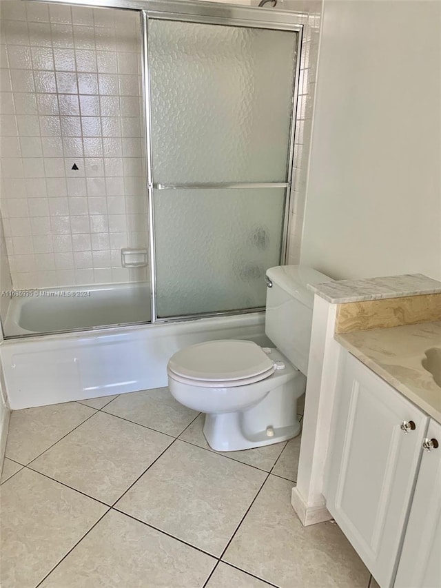 full bathroom with vanity, toilet, tile patterned floors, and shower / bath combination with glass door