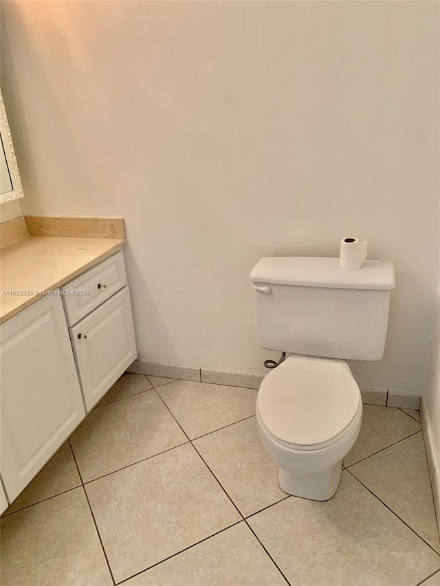 bathroom with vanity, toilet, and tile patterned flooring