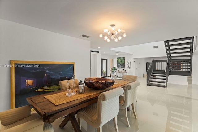 dining space featuring light tile patterned floors and a notable chandelier