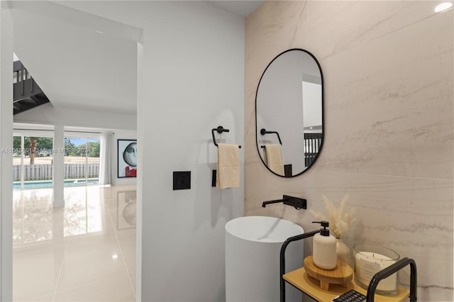 bathroom featuring tile patterned flooring and tile walls