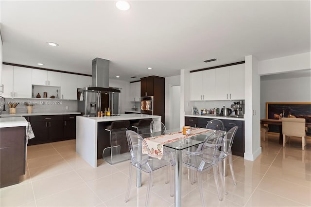 tiled dining space featuring a fireplace and sink